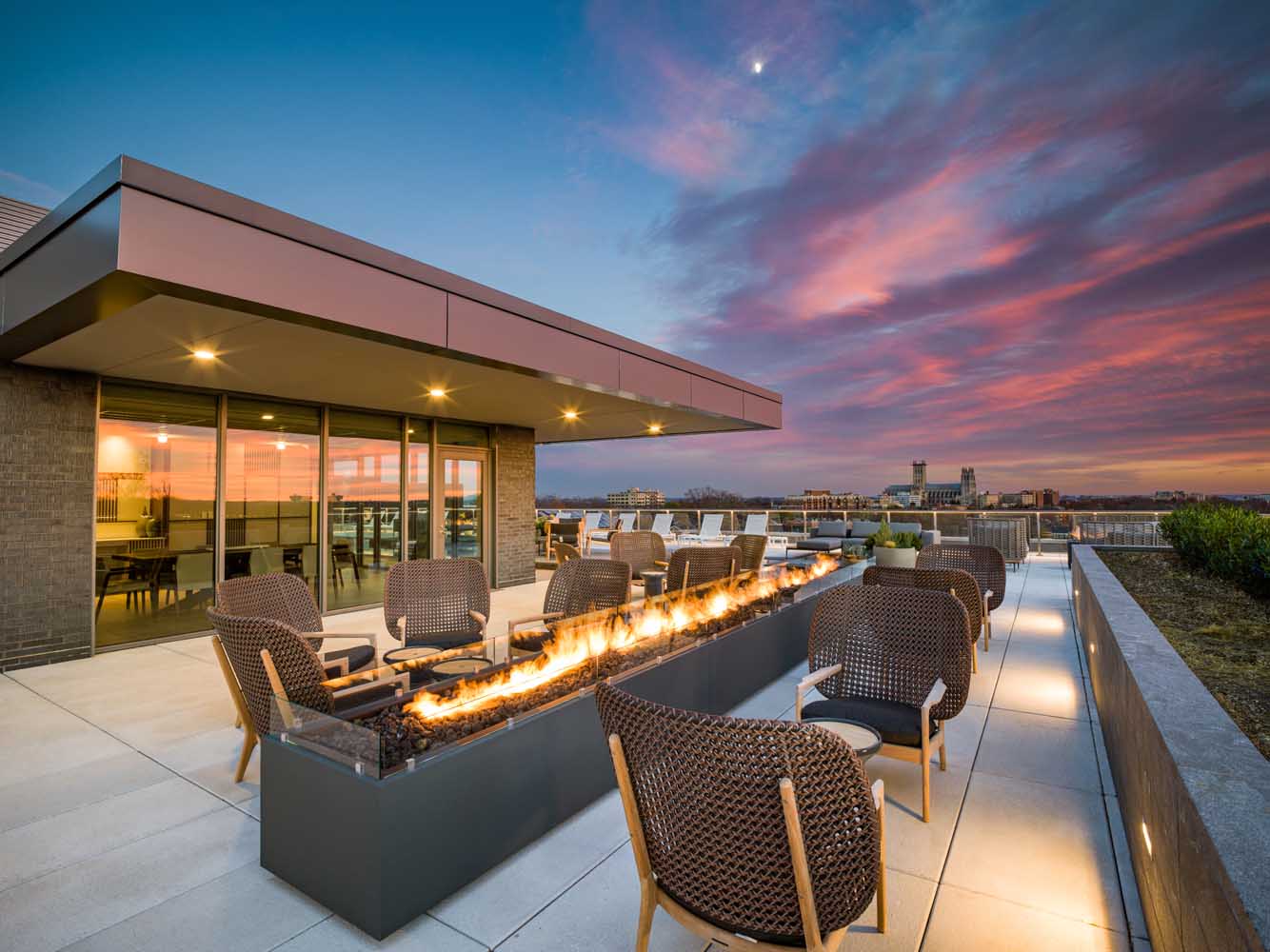 Enjoy the rooftop entertainment suite over the warmth of the outdoor fireplace